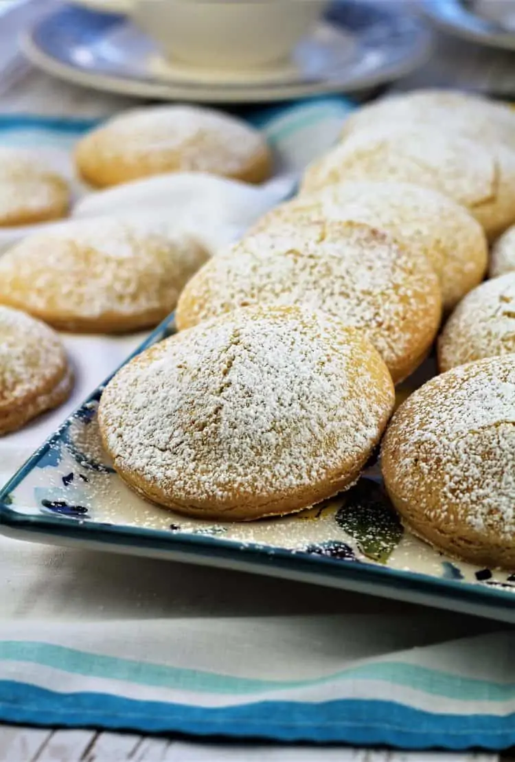 sweet panelle cookies dusted in powdered sugar on rectangular plate 