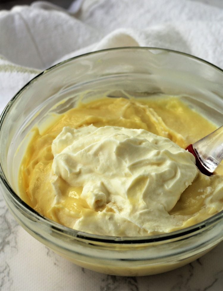 rubber spatula folding whipped cream into pastry cream