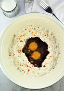 mixing bowl with flour with eggs and Marsala wine in the center