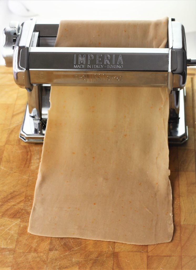 pasta roller with sheet of dough in it