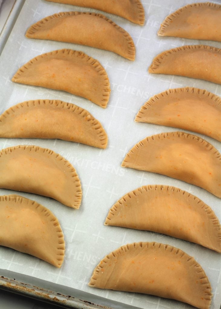 filled cassatelle crescents on baking sheet 