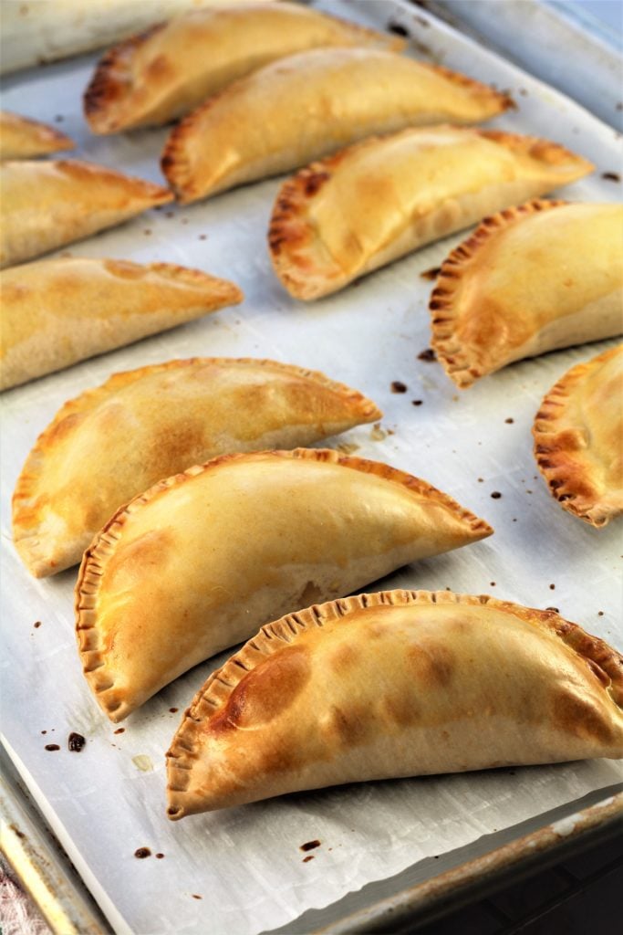 baked cassatelle crescents on baking sheet