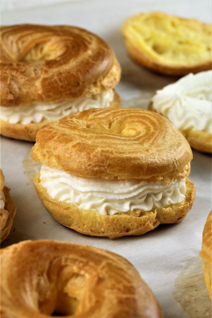 choux pastry filled with ricotta cream on parchment paper with other choux