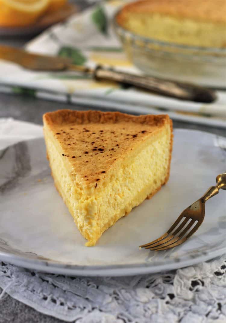 wedge of ricotta pie on white plate with fork 