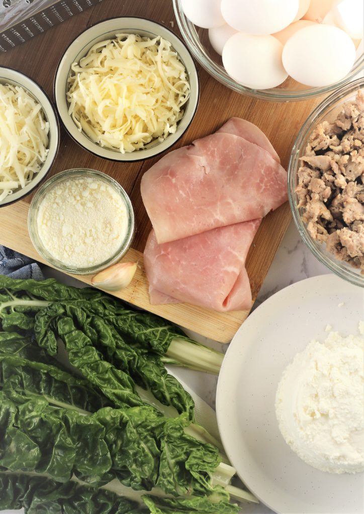 ingredients for pizza rustica including cheeses, sausage, eggs, swiss chard and ham