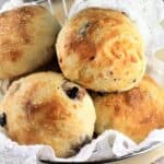 Italian olive and cheese stuffed buns piled in basket.