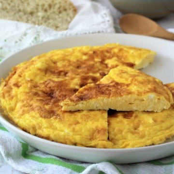 ricotta frittata cut into wedges on white plate