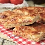 overlapping slices of parigina pizza on red checked paper