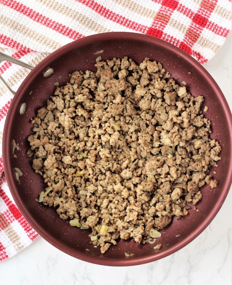 red skillet with cooked ground meat 