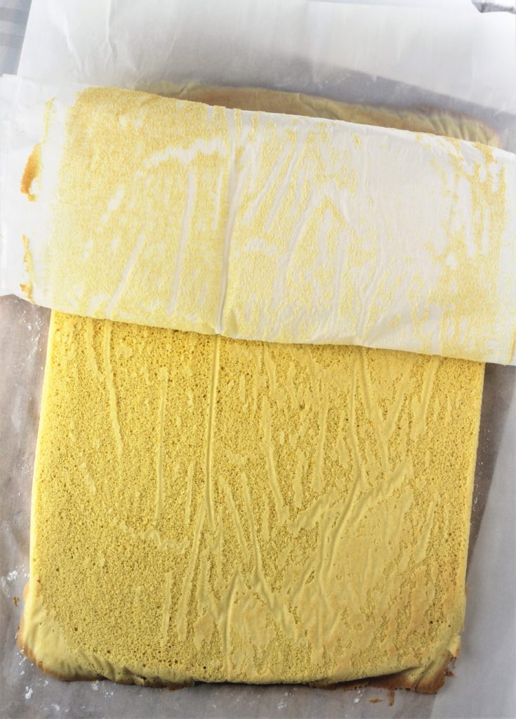 peeled baking sheet from roll cake on baking sheet 