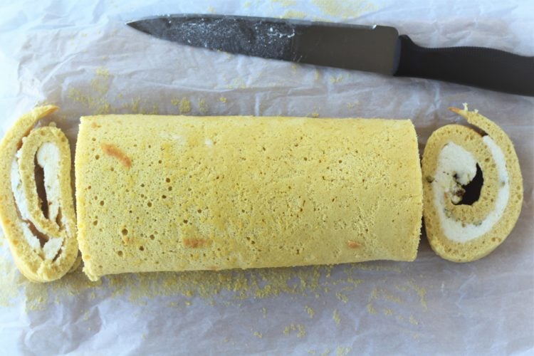 trimming ends from roll cake with ricotta with knife