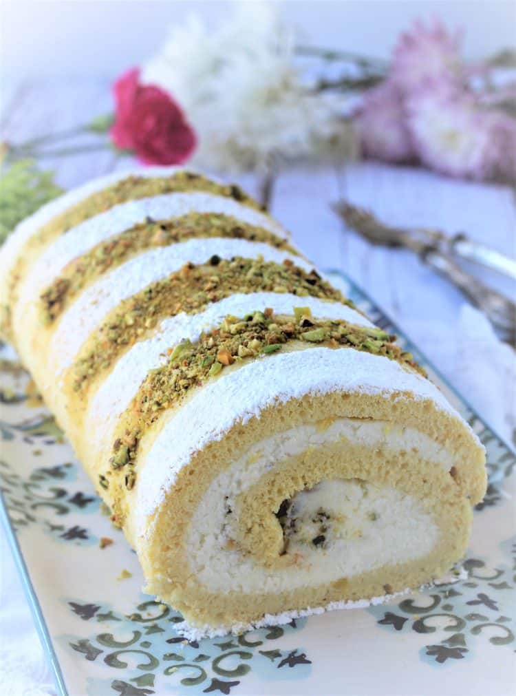ricotta pistachio roll cake on cake plate 