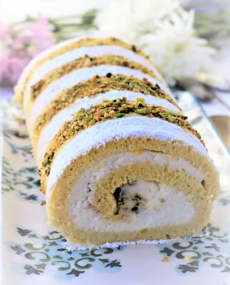ricotta and pistachio roll cake on serving platter