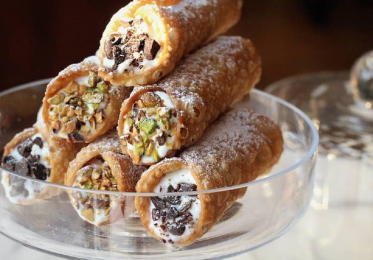 cannoli with ricotta piled on glass plate