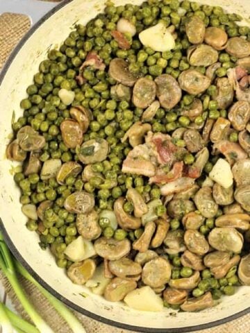 Spring vegetable stew (frittedda recipe) with peas and fava beans in large skillet.
