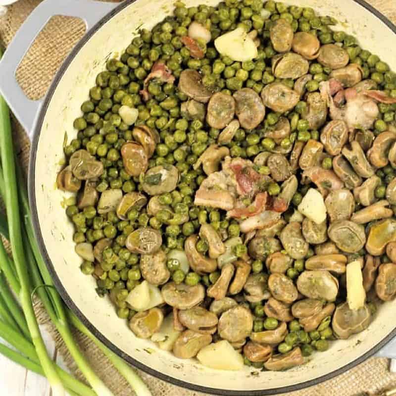 Spring vegetable stew (frittedda recipe) with peas and fava beans in large skillet.