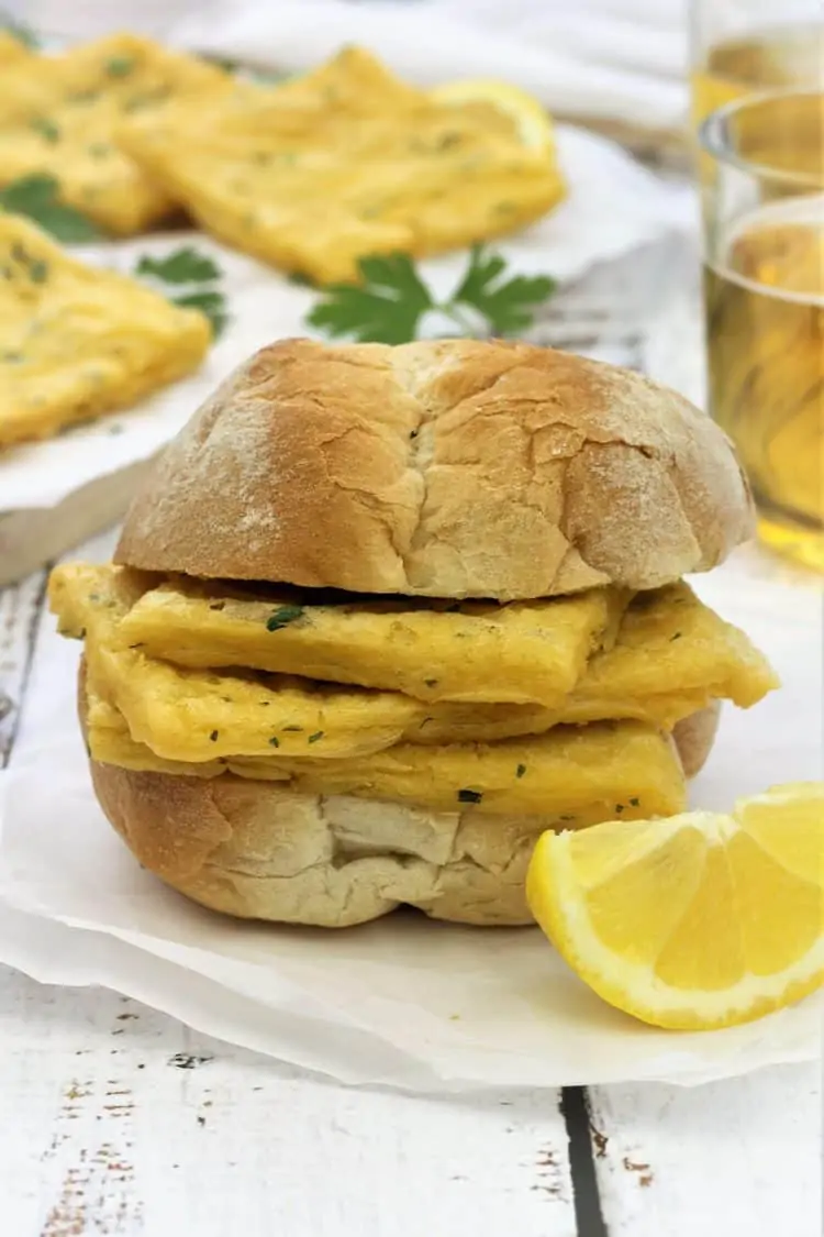 crusty bun with panelle and lemon wedge on side