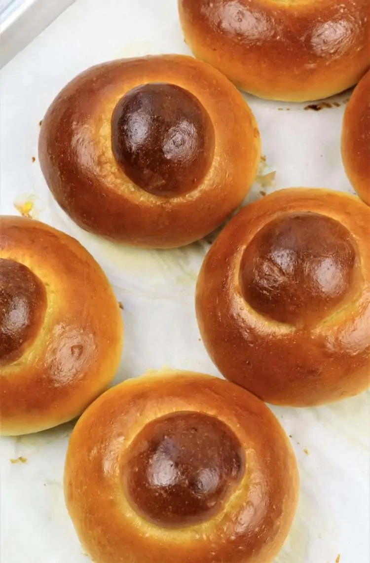baked brioche on parchment covered baking sheet 