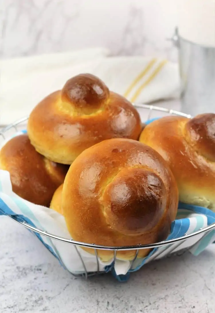 basket filled with Brioche with a bun on top