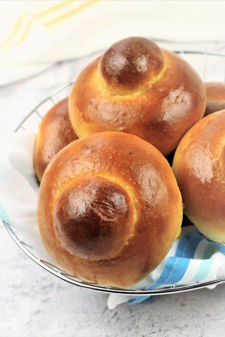 basket filled with brioche with a bun on top