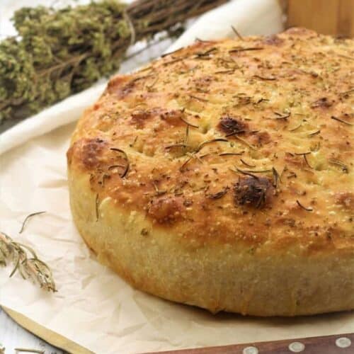 No knead cast iron focaccia bread topped with herbs.