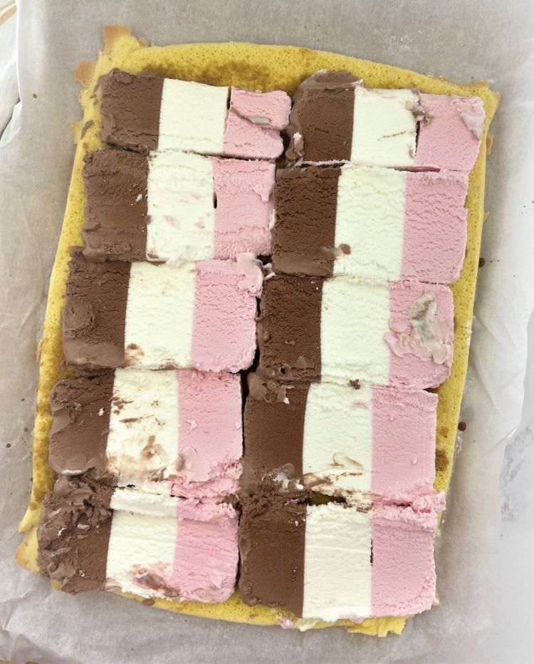 slices of Neapolitan ice cream on flat sponge cake