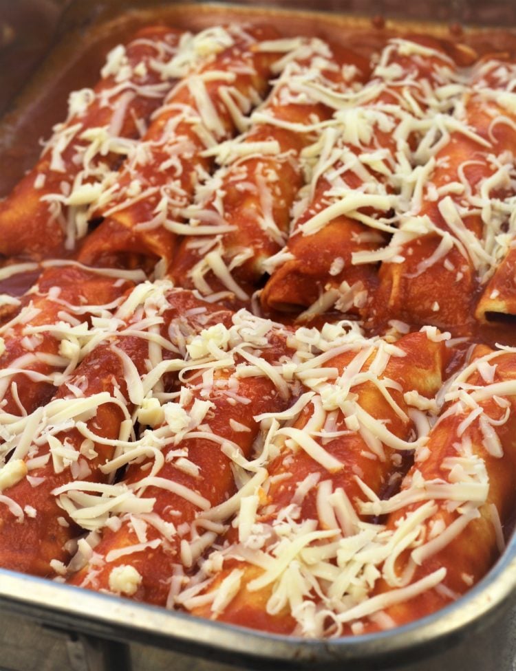 crepes topped with tomato sauce and mozzarella in baking dish