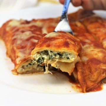 a forkful of crepe cannelloni with ricotta and spinach