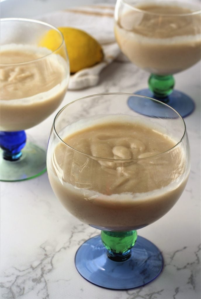 almond milk pudding poured into stemmed glasses