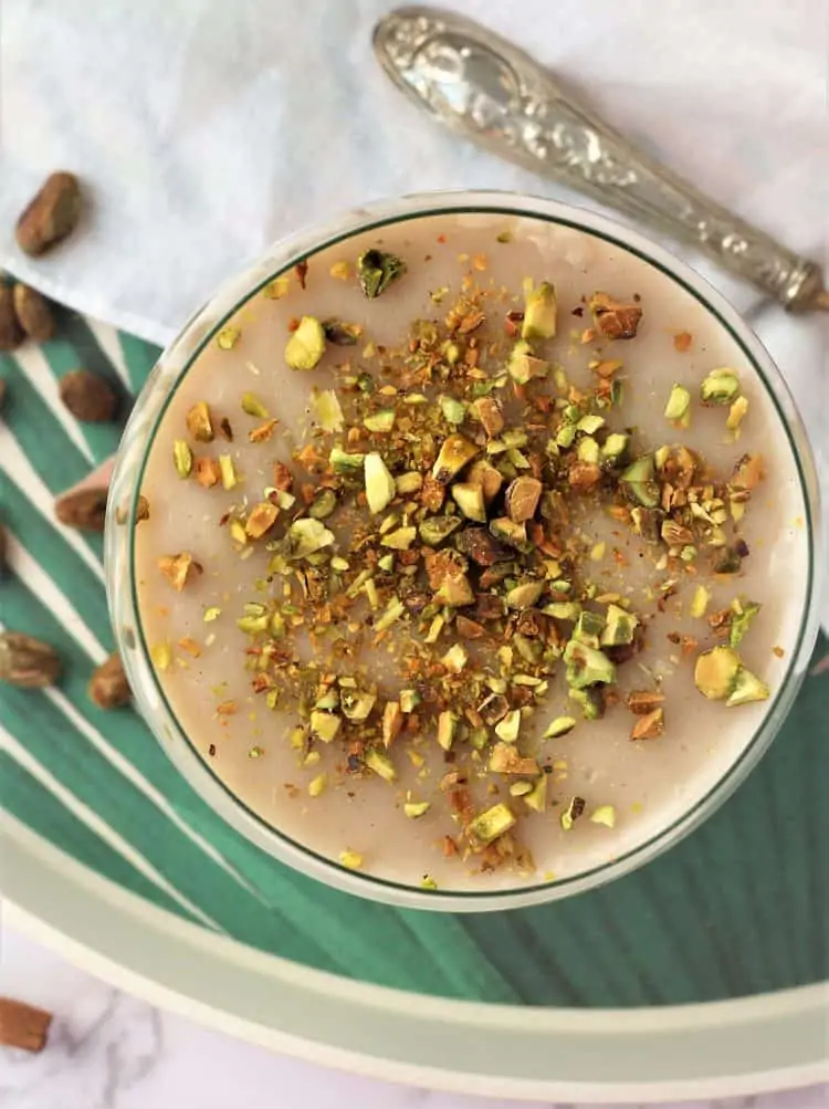 overhead view of almond milk pudding topped with chopped pistachios