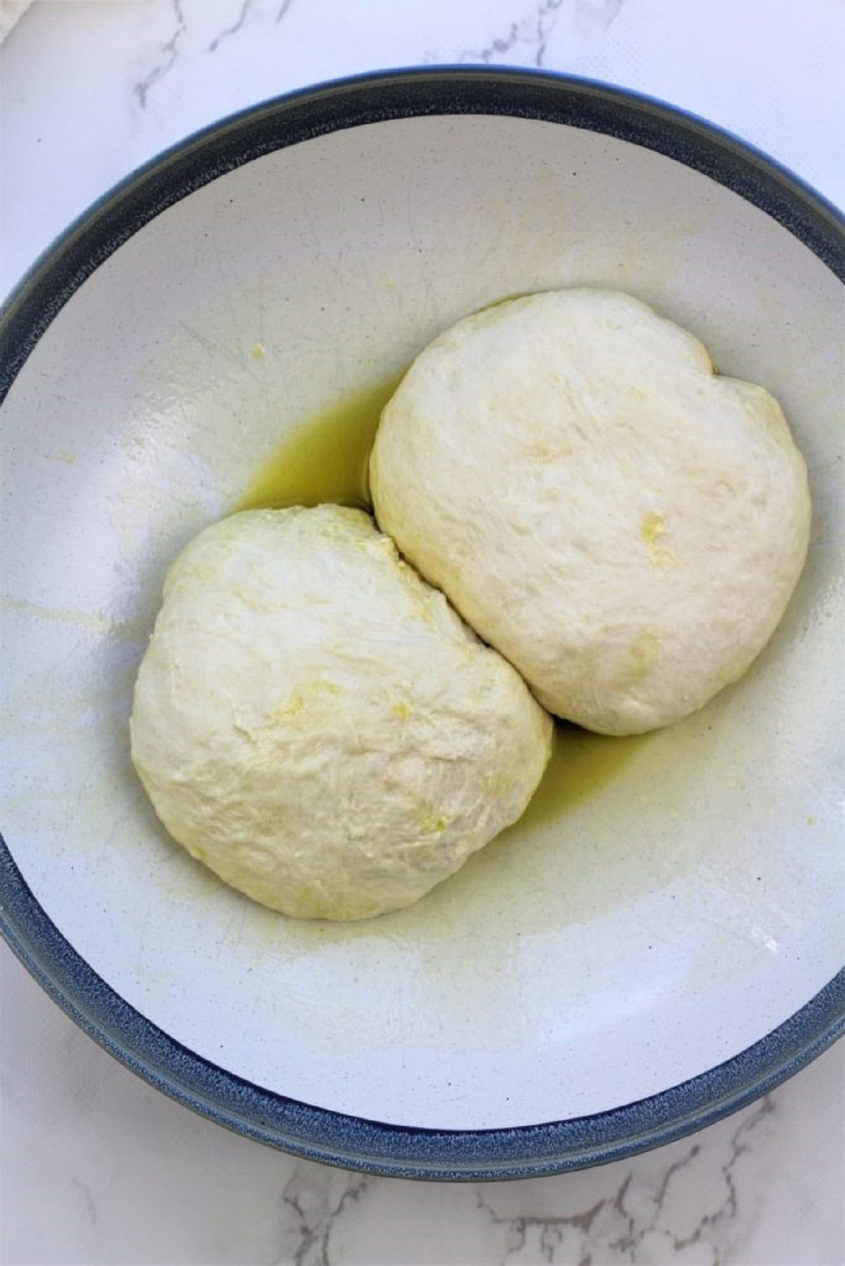 No knead pizza dough for scacciata recipe divided in two balls.