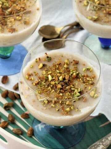 Biancomangiare- Sicilian almond milk pudding, served in glasses and topped with chopped pistachios.