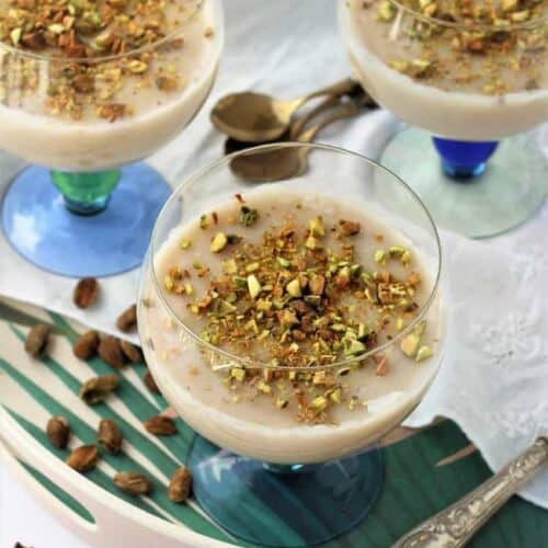Biancomangiare- Sicilian almond milk pudding, served in glasses and topped with chopped pistachios.