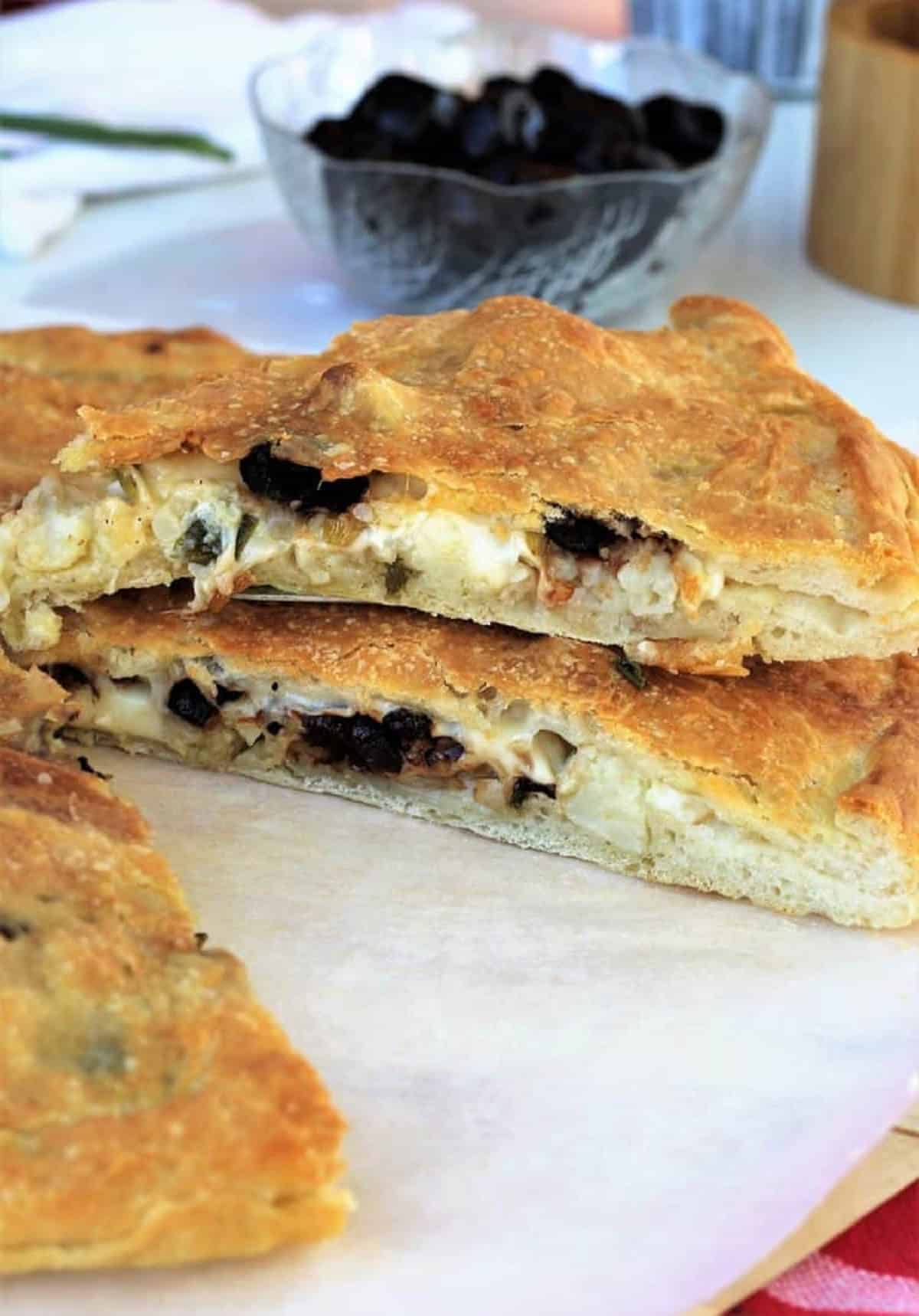 Scacciata with Cauliflower and Black Olives (No Knead Recipe) Slices of scacciata filled with cauliflower and black olives.