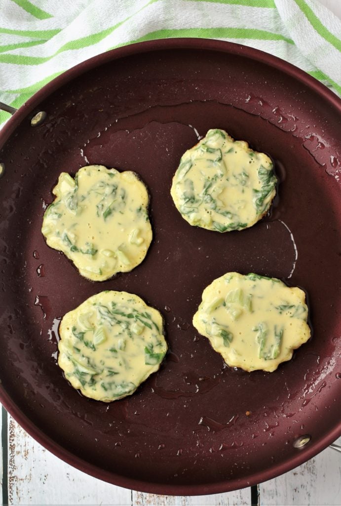 swiss chard fritters frying in large skillet 