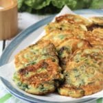 swiss chard fritters layered in blue rimmed platter