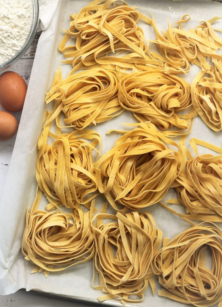 nests of fresh tagliatelle pasta on tray