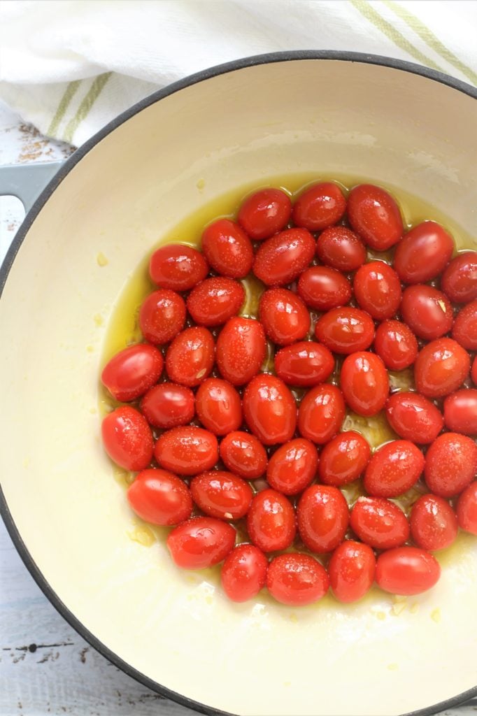 whole cherry tomatoes with olive oil in large skillet
