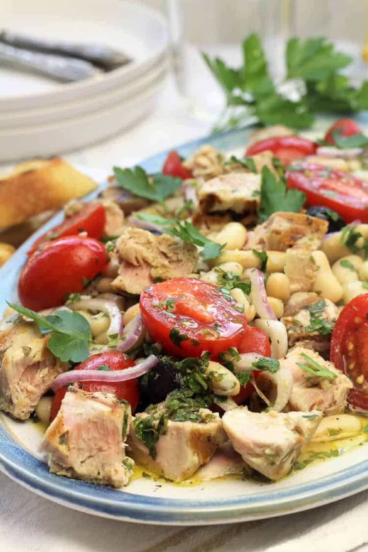 Tuna and white bean salad on oval plate.