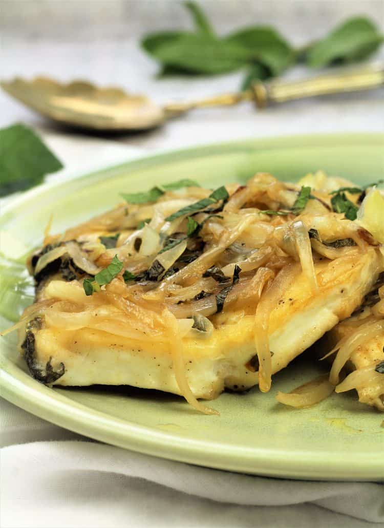 fish steak topped with sautéed onions and mint