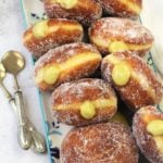 pistachio cream filled sugar doughnuts on serving platter