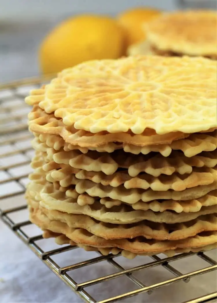 stacked pizzelle cookies on wire rack