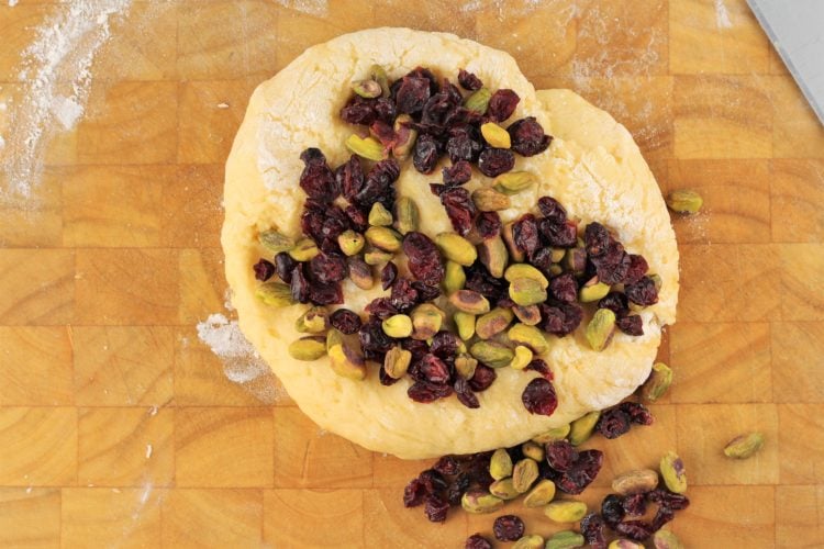 pistachios and dry cranberries on circle of biscotti dough