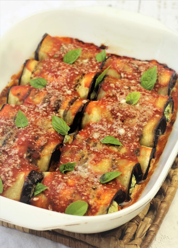 baked eggplant involtini with basil leaves on top