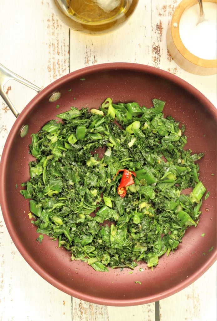 skillet filled with sautéed greens