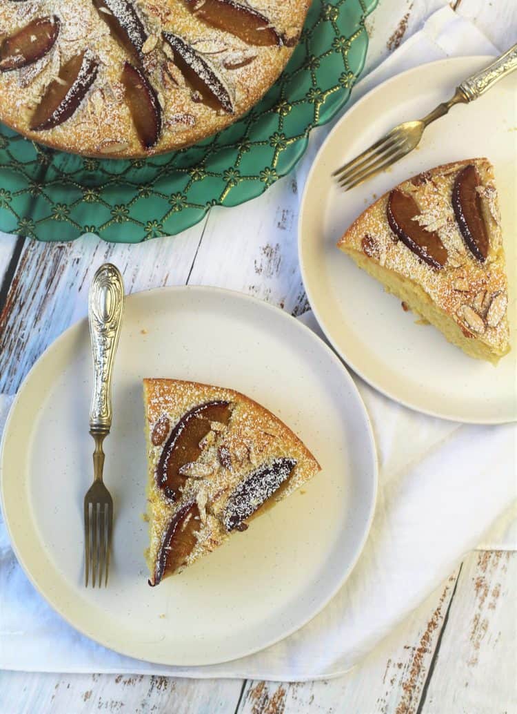 wedges of plum almond cake on plates with forks