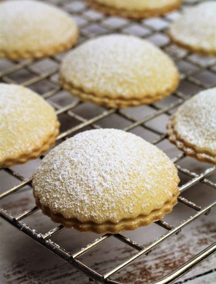 baked Genovesi Ericine dusted with powdered sugar on wire rack