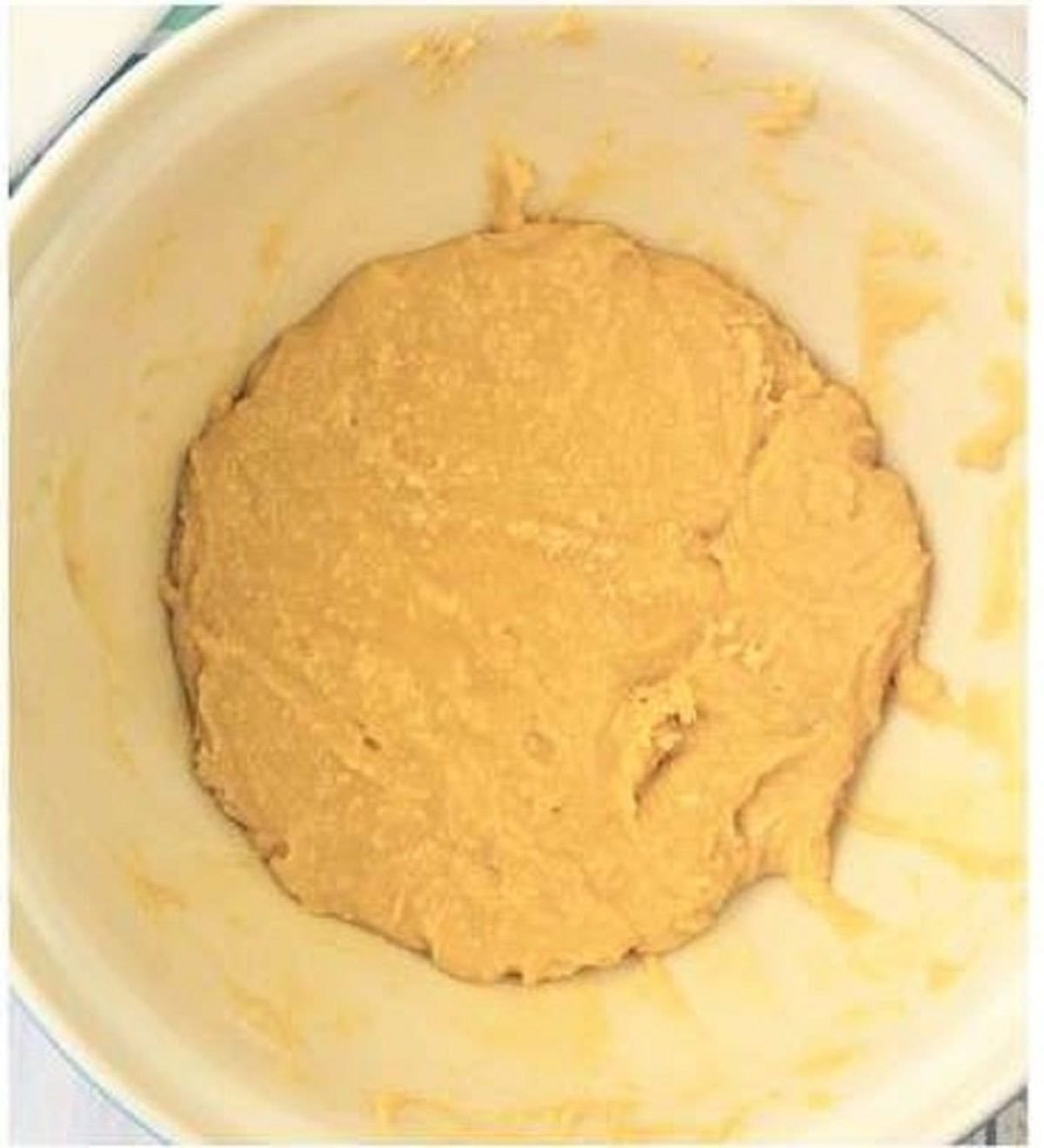 Almond flour cake batter for plum cake in bowl.