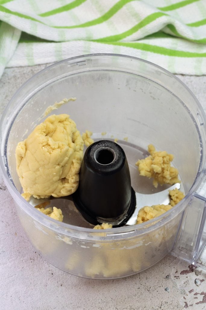 ball of dough wrapped around blade in food processor bowl 