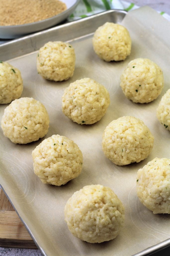 assembled arancini balls on baking sheet